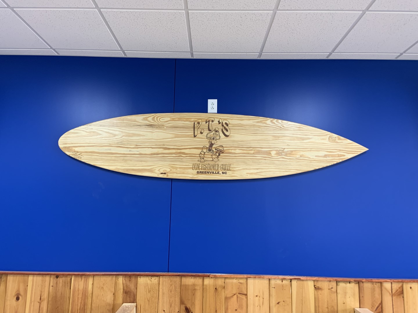 P.T Grille surf board on wall